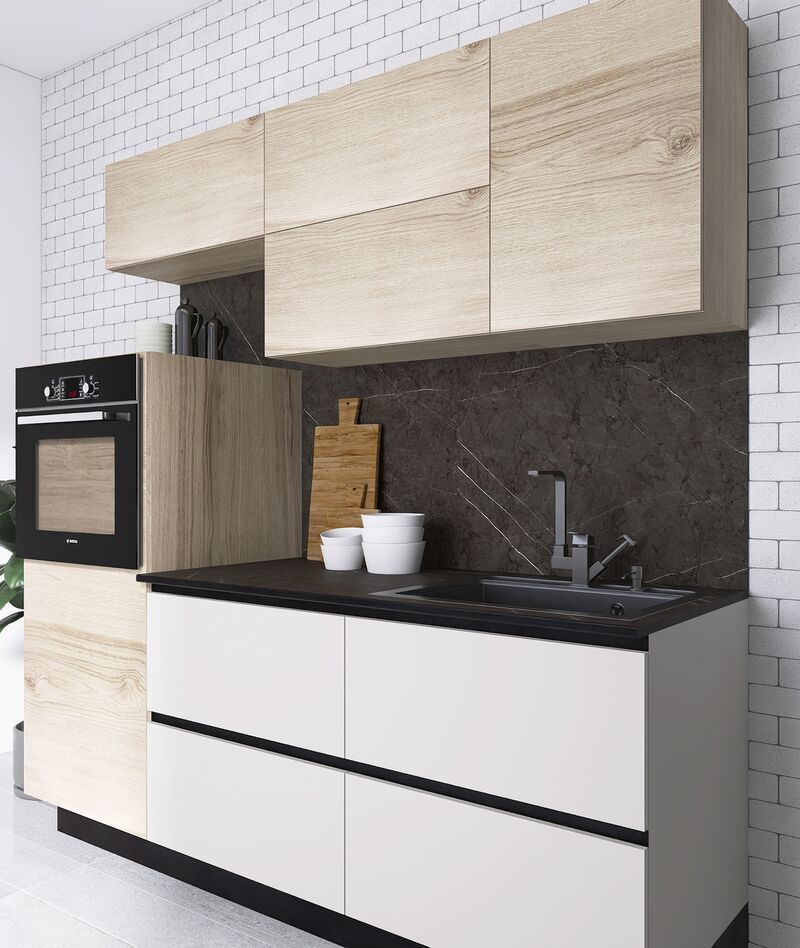 Cocina con cubierta Khör oscura y muro de ladrillo blanco